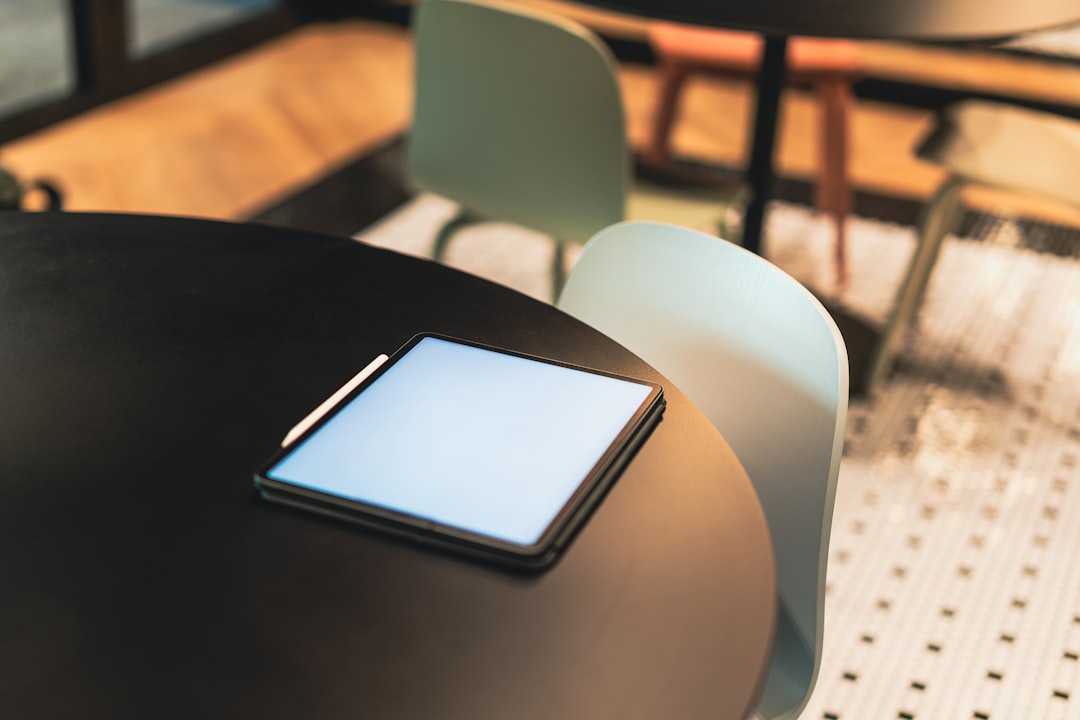 A cell phone sitting on top of a black table
