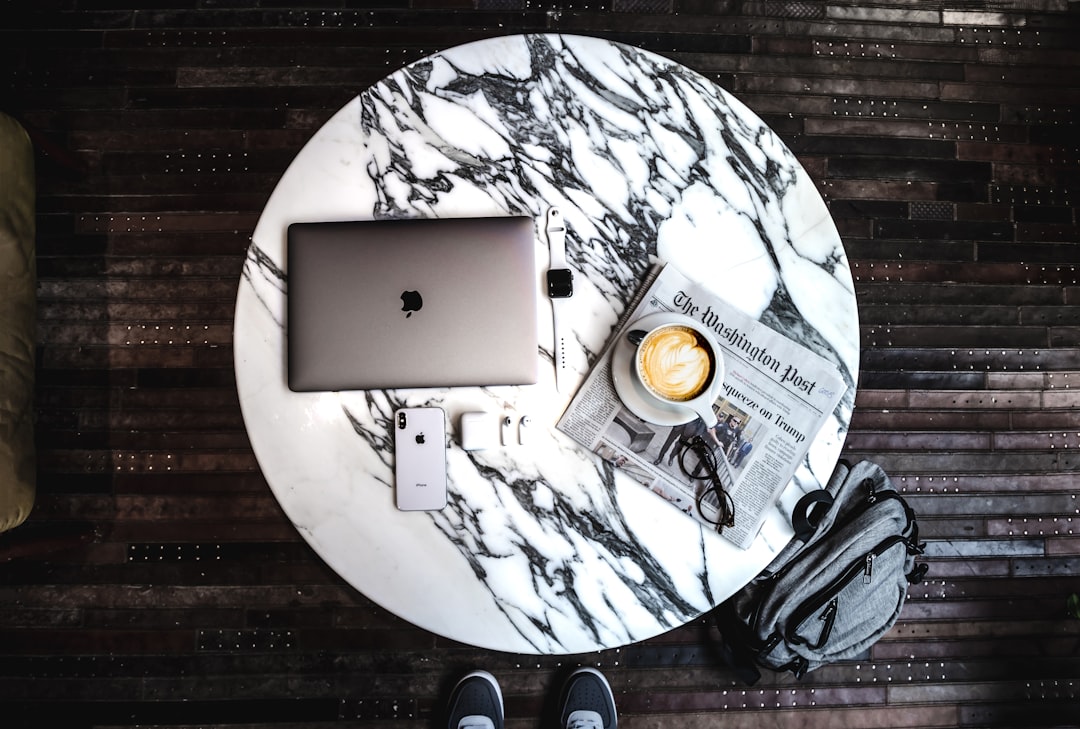 silver ipad on brown wooden table